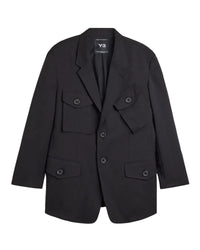A black Y-3 blazer jacket with multiple flap pockets and a double-breasted button closure, displayed flat against a light gray background.